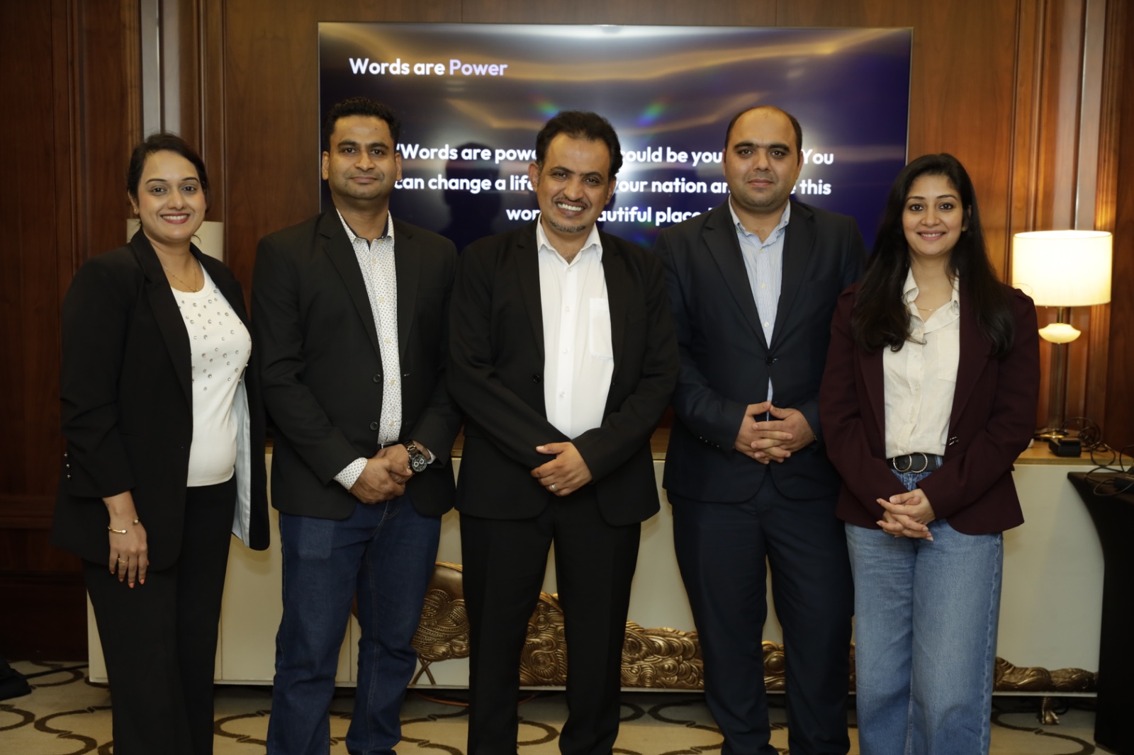 Group photo with Mohammed Qahtani in front of the Words are Power slide