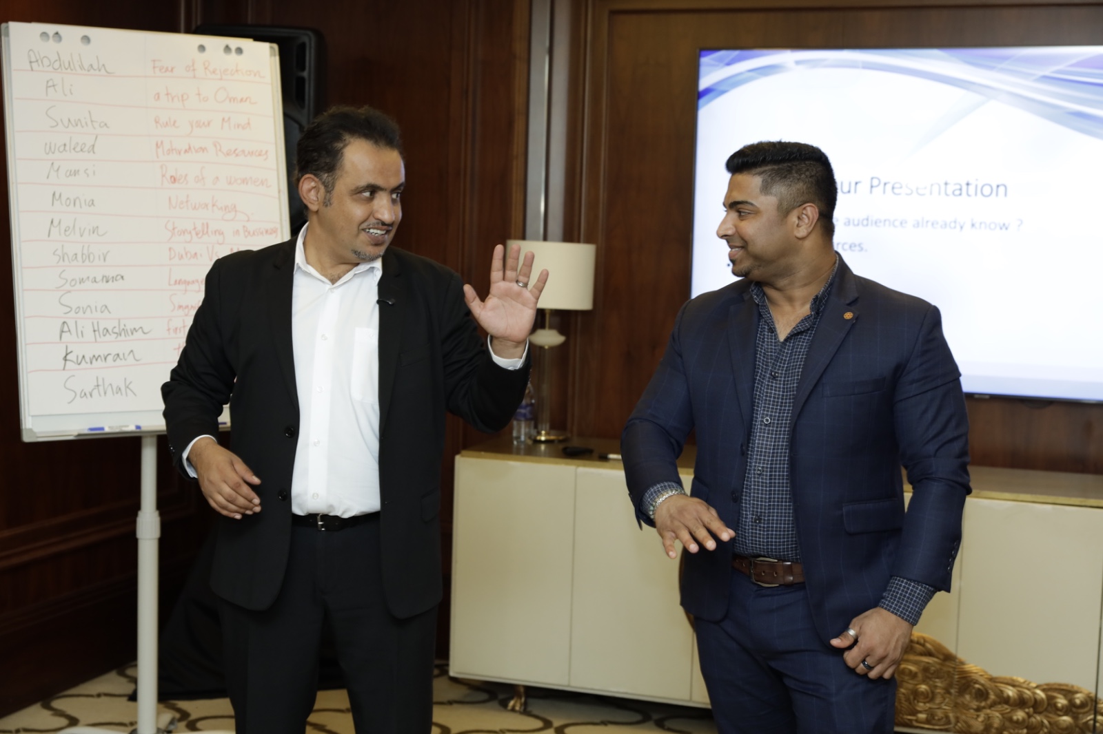 Mohammed Qahtani coaching a participant beside the flip chart